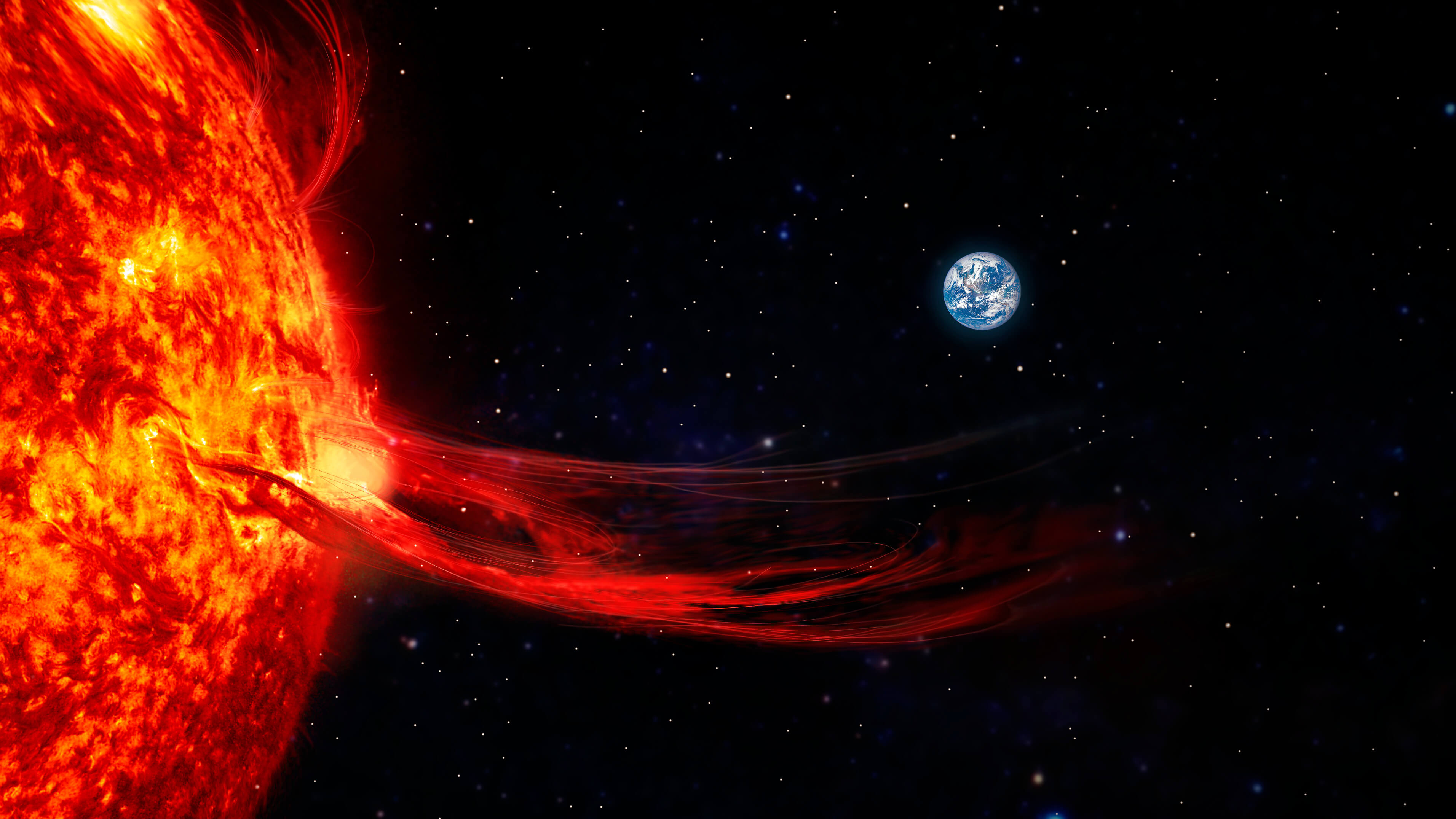 A solar flare extends from the surface of the Sun toward space, with the Earth visible in the distance against a backdrop of stars.